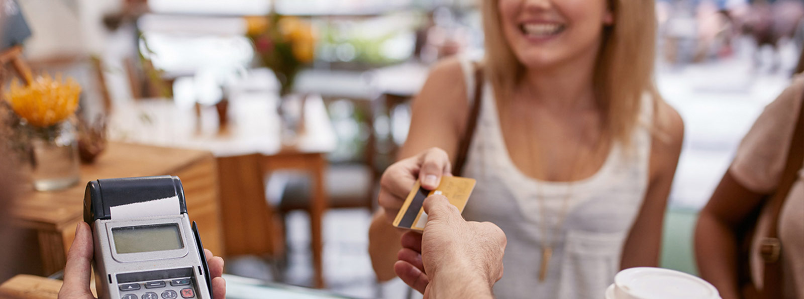 Lady using a credit card at a business