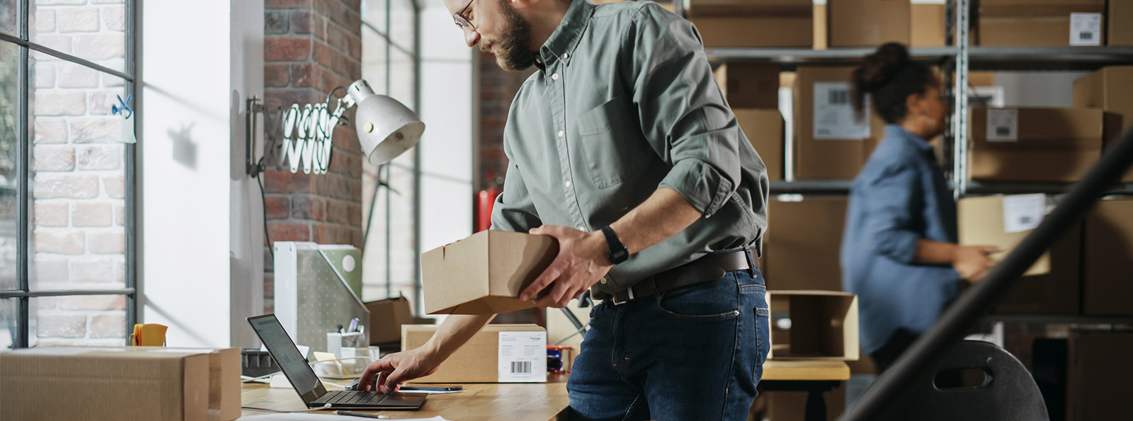 A man in his commercial business using a laptop computer