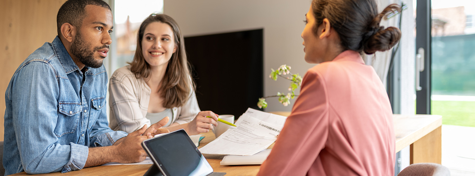 A couple meeting with an officer at the bank about CDs