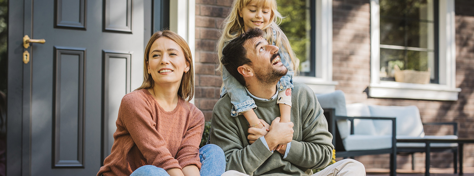 A family enjoying time together on their front porch